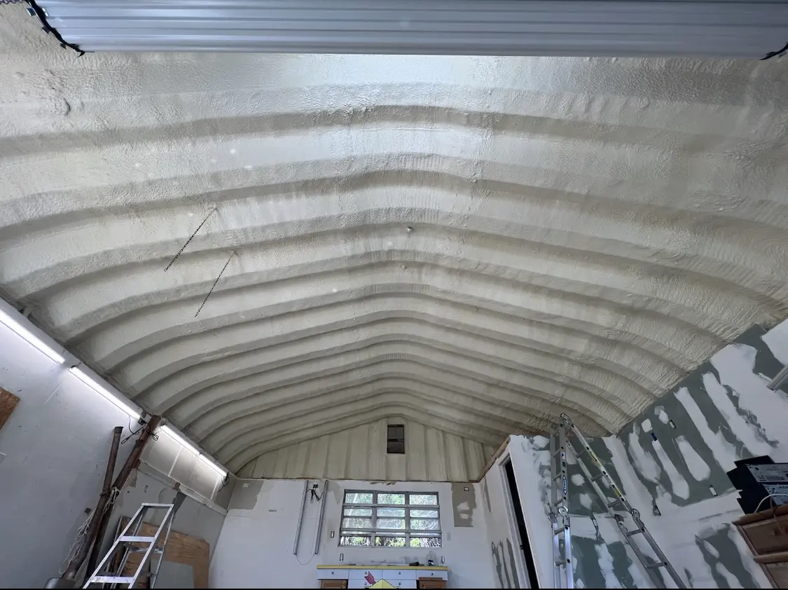 Spray polyurethane foam applied to the underside of a metal roof deck in Rockingham